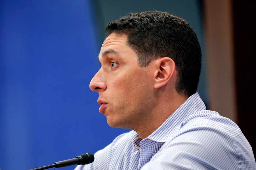 In this July photo, Rangers general manager Jon Daniels answers a question during a news...