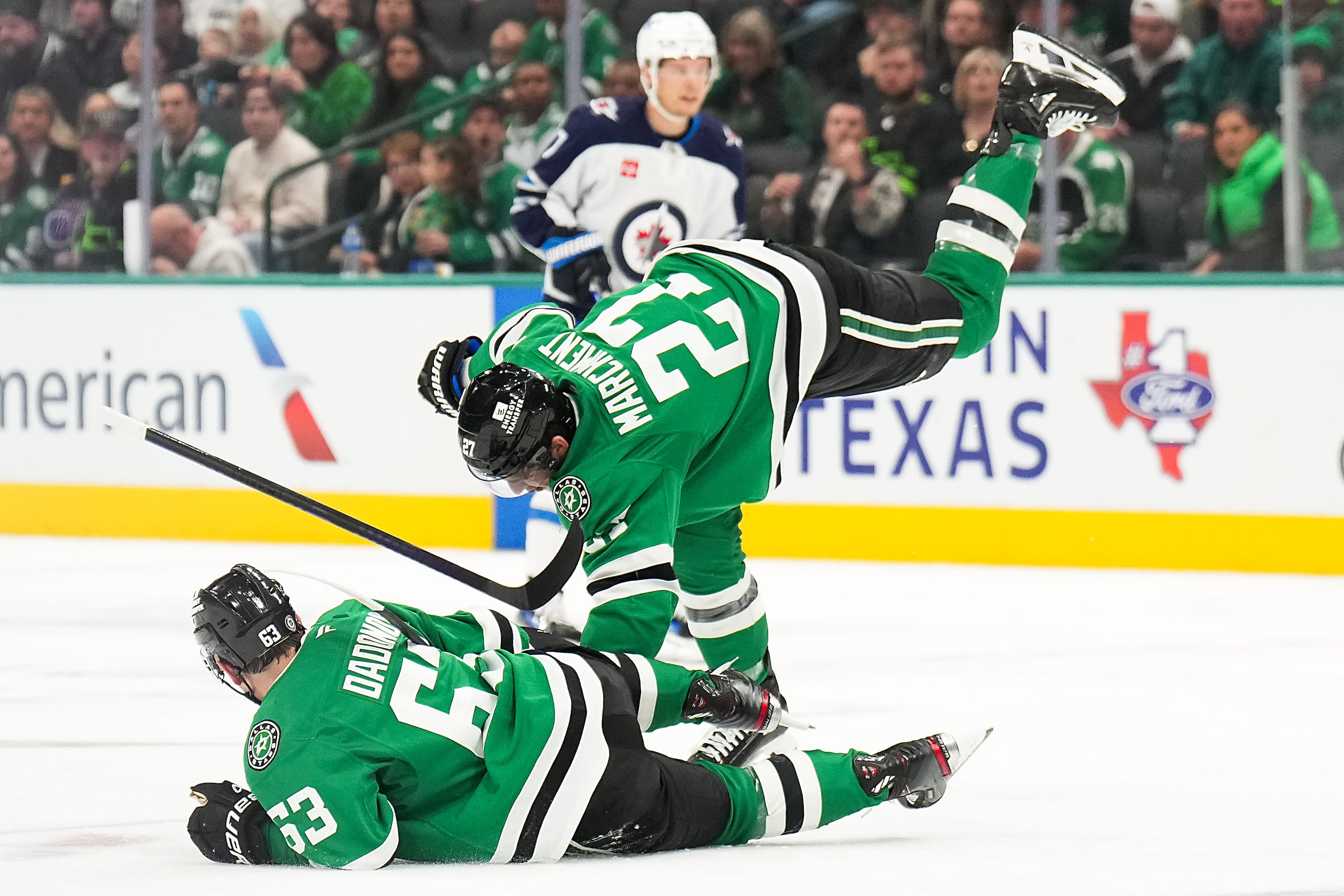 Dallas Stars left wing Mason Marchment (27) collides with teammate Evgenii Dadonov (63)...