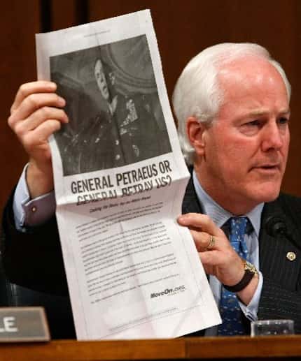 In this 2007 file photo, Sen. John Cornyn, R-Texas, holds up a copy of an ad paid for by...