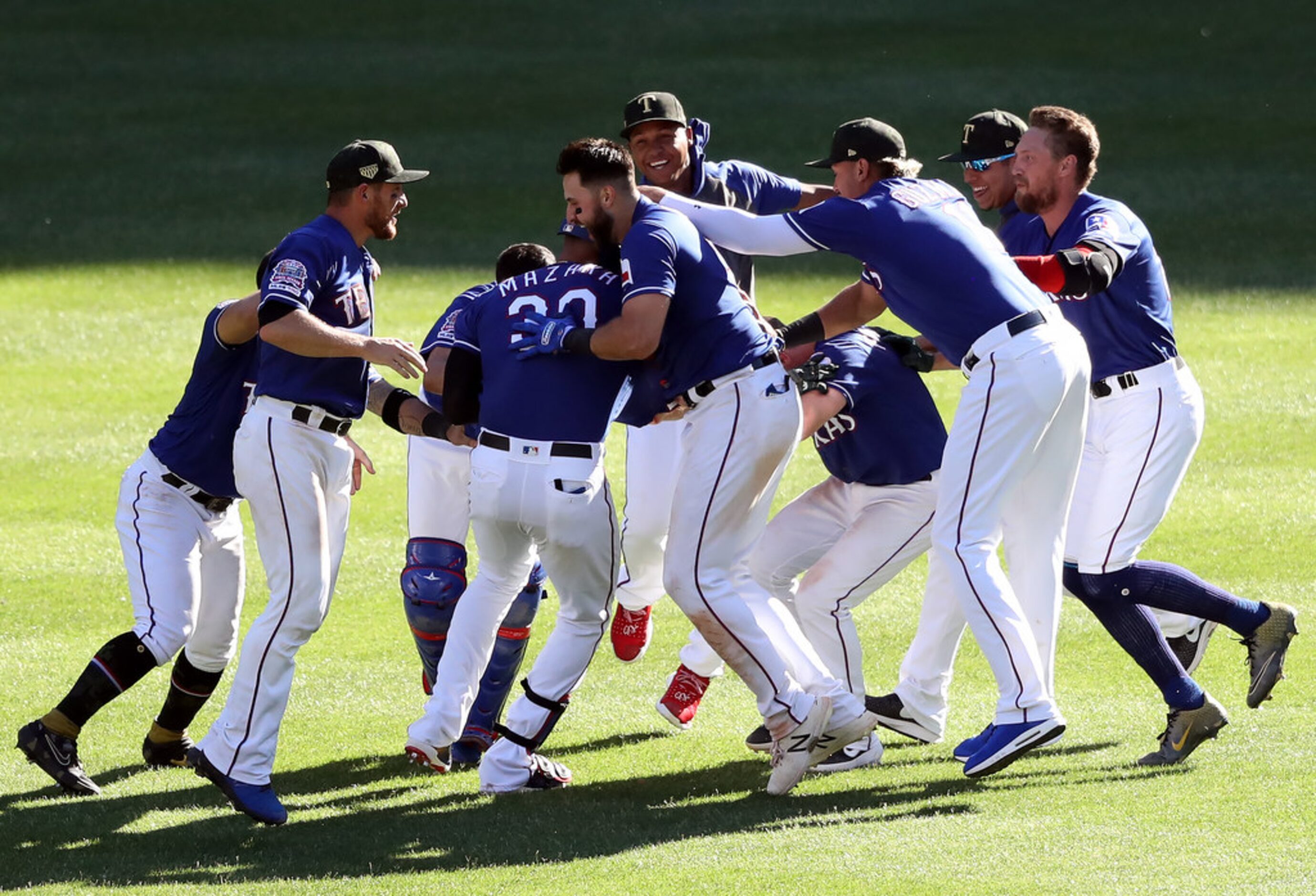 ARLINGTON, TEXAS - MAY 19:  The Texas Rangers celebrate the game winning run scored on a...