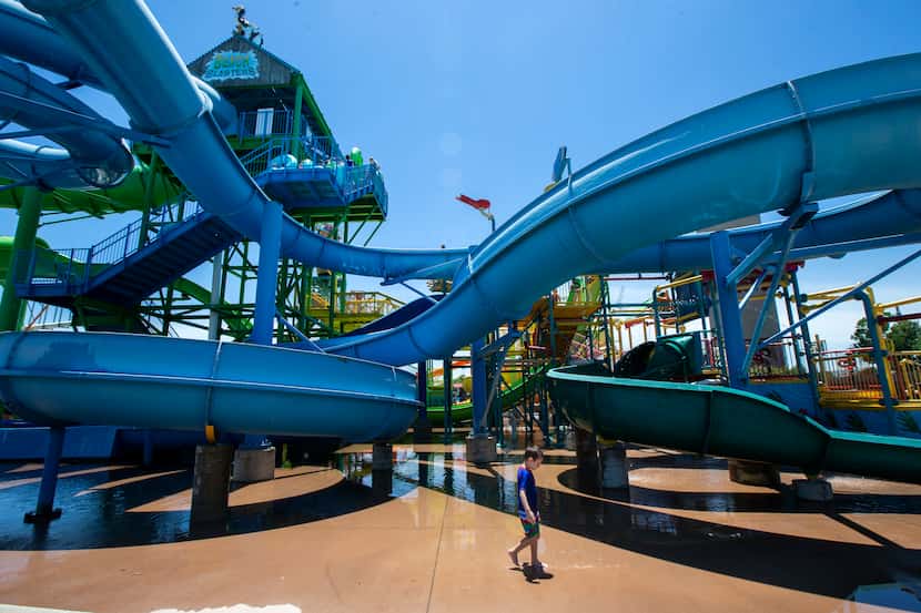 In a taste of summertime fun, children enjoy the water attractions at Hawaiian Falls water...