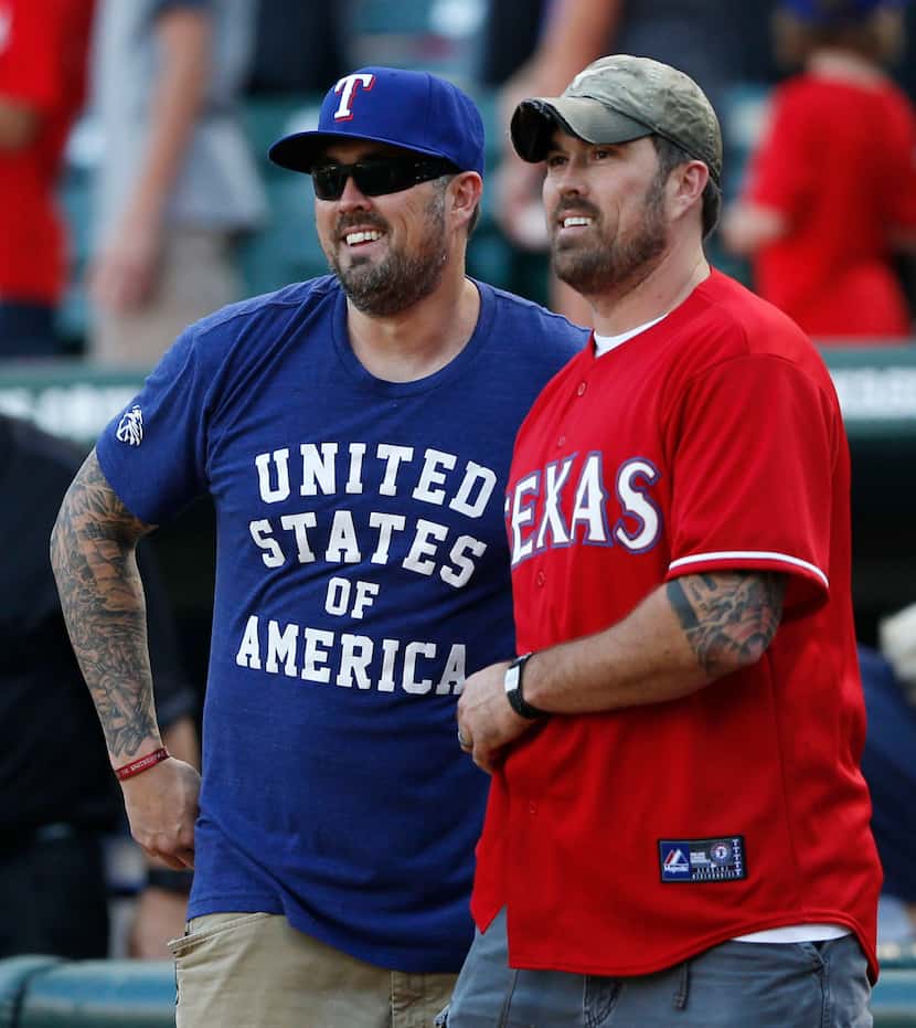 Marcus (left) and Morgan Luttrell before throwing the first pitch before a game between the...