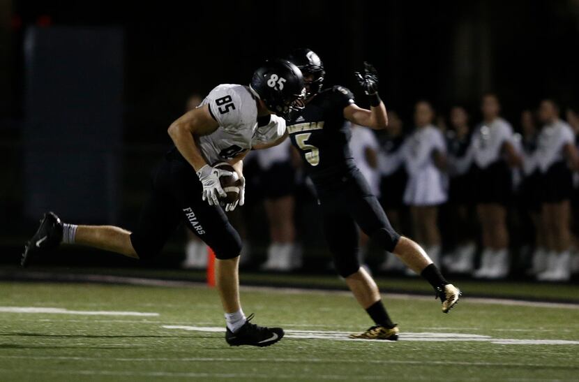 Bishop Lynch's Jack Bradley (85) hauls in the pass as Kaufman's Michael Glick (5) defends in...