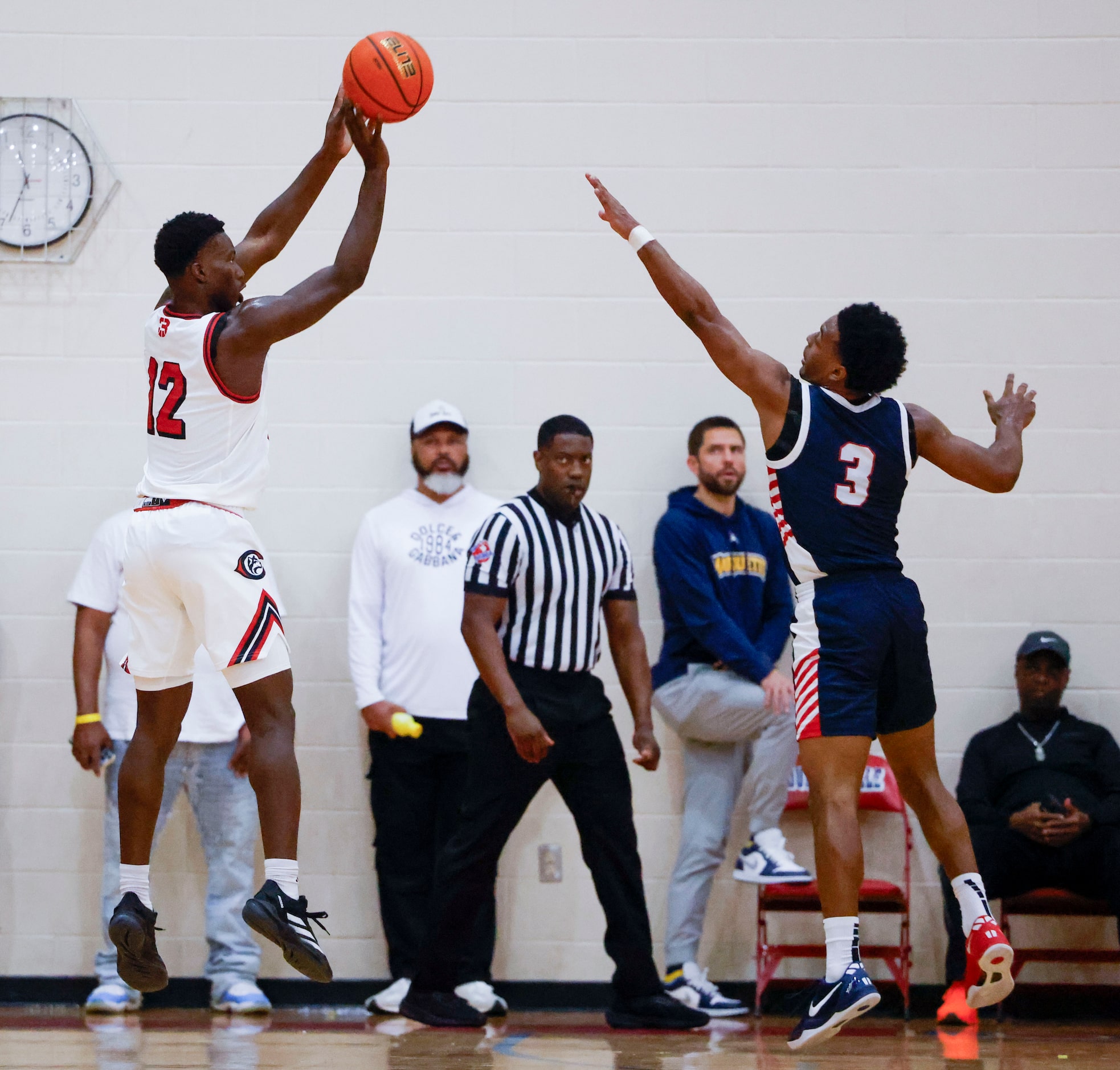 Centennial High’s  Tariq Iscandari (left) shoots a three pointer as Kimball High’s David Coe...