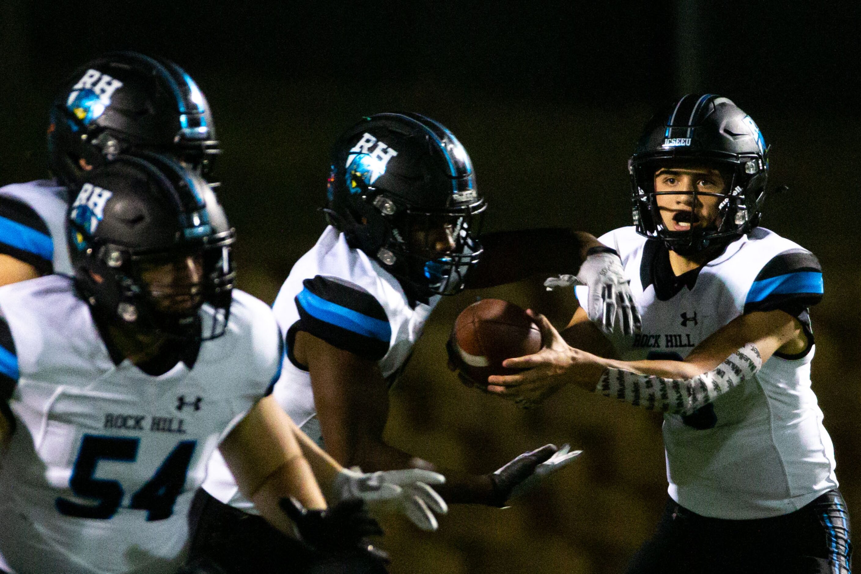 Rock Hill quarterback Brenner Cox (4, left) passes to running back Donovan Shannon (22,...