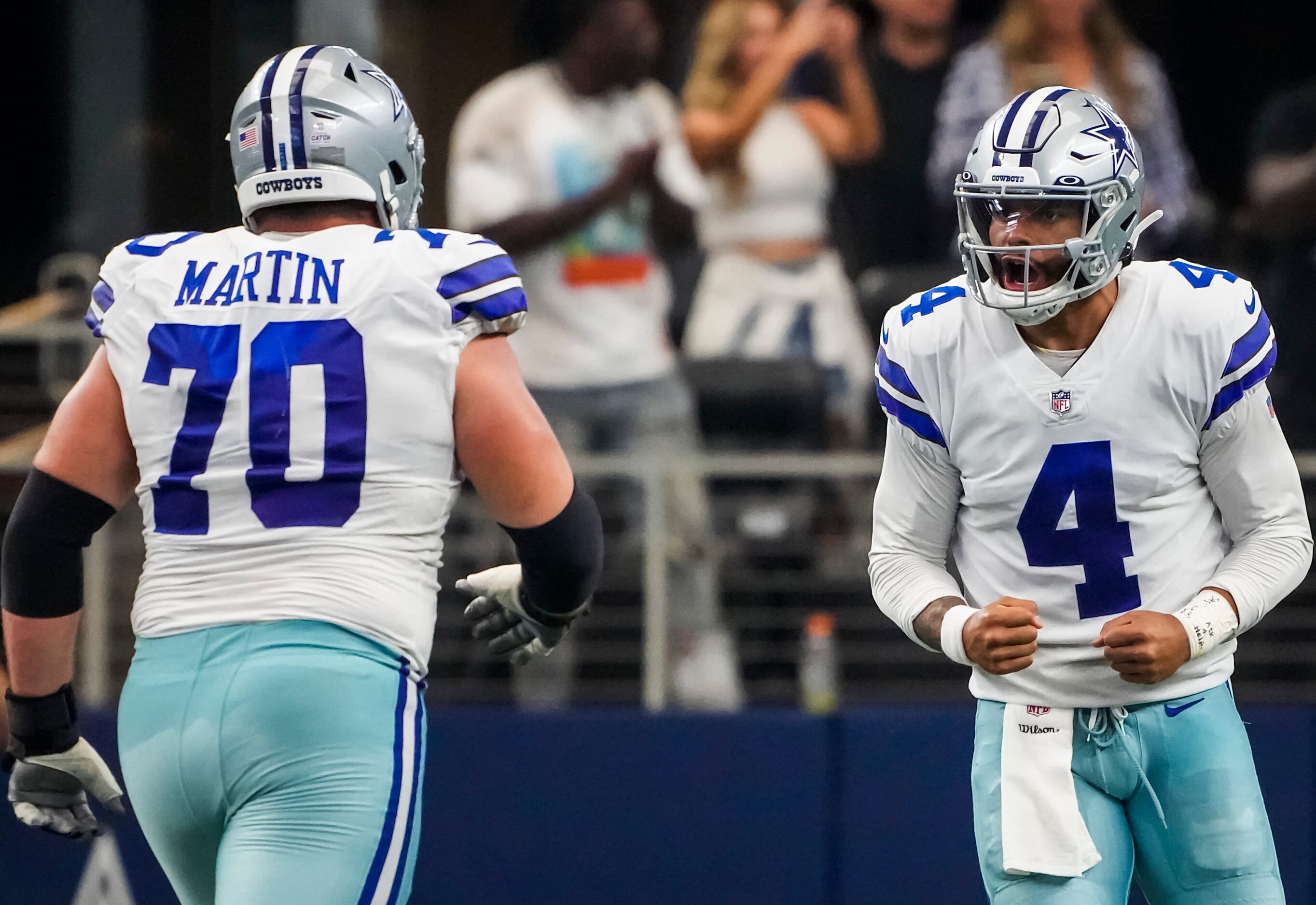 Dallas Cowboys quarterback Dak Prescott (4) celebrates with offensive guard Zack Martin (70)...