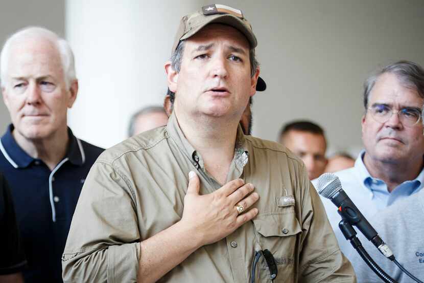 Sen. Ted Cruz is surrounded by fellow lawmakers and law enforcement as he addresses a press...