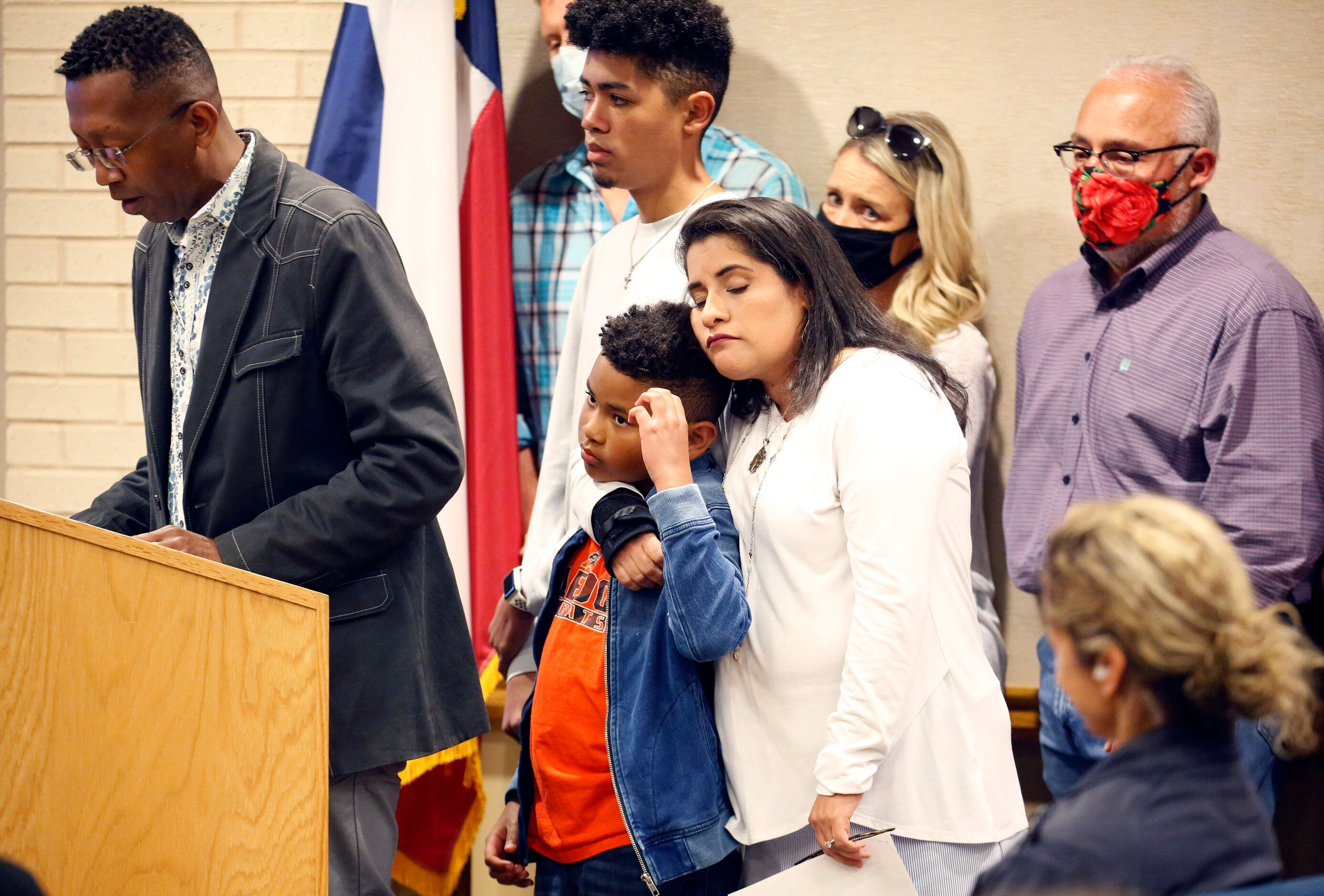 Parent Maria Turner hugs one of her two boys after telling the Aledo ISD school board about...