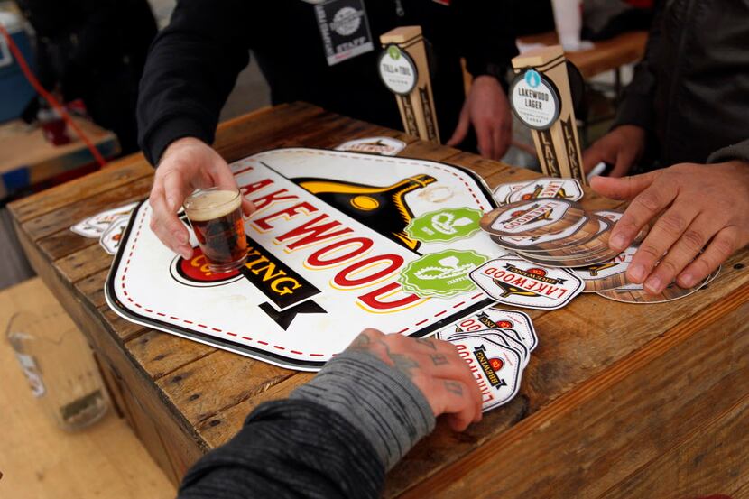 A person gets his glass of beer from Lakewood brewing Co. tent during the Untapped Indie...