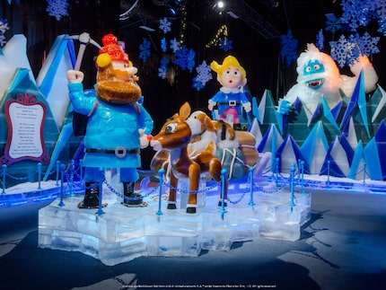 A scene created in carved ice showing Rudolph the Red-Nosed Reindeer, Hermey the Elf, and...