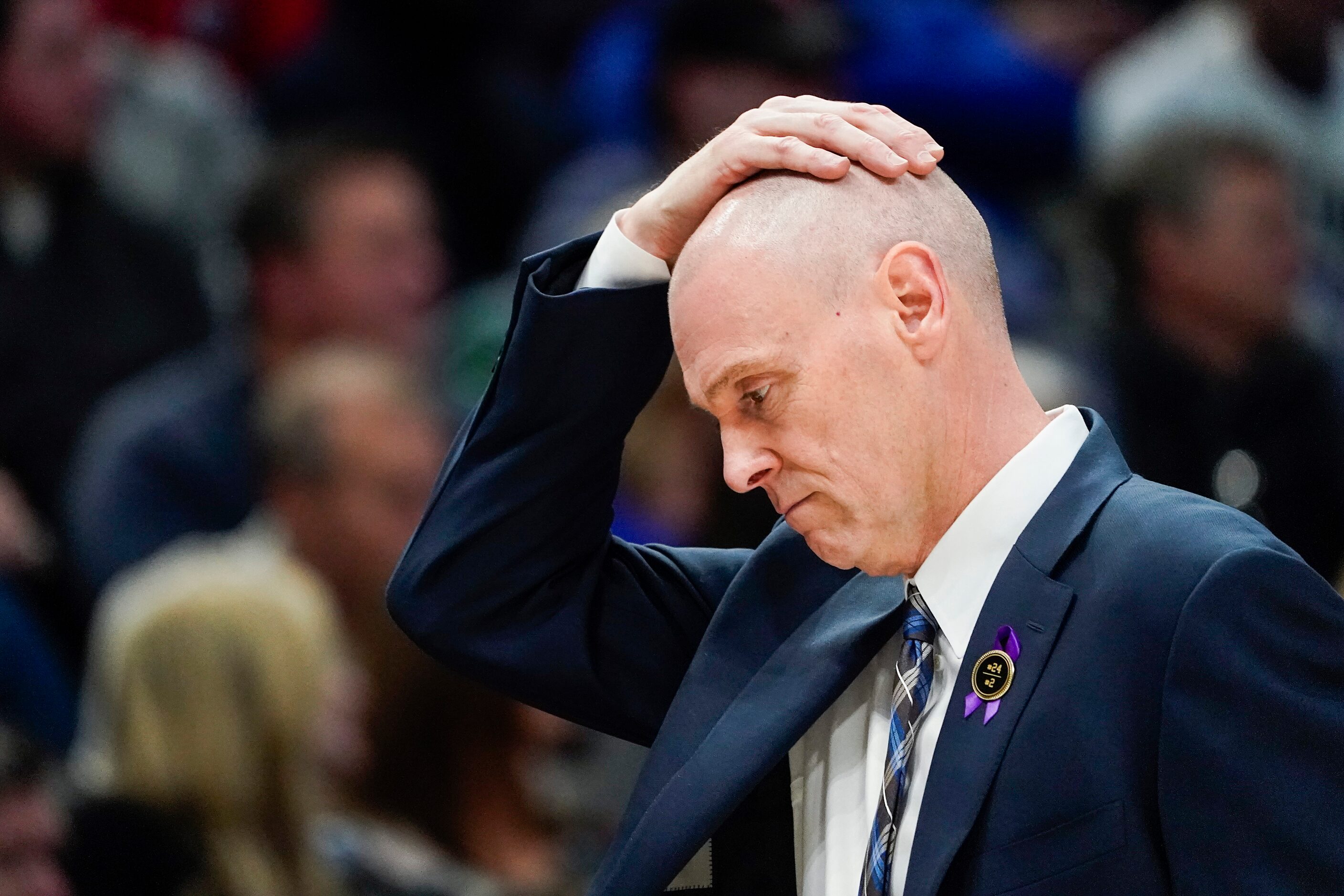 Dallas Mavericks head coach Rick Carlisle rubs his head in between plays during the first...