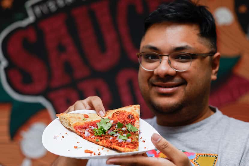SauceBros Pizza co-owner Redwan Huda holds a Naga Habanero Balachao pizza on Thursday, April...