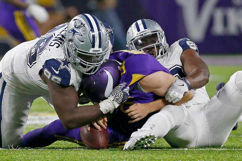 Minnesota Vikings quarterback Sam Bradford (8) is sacked by Dallas Cowboys defensive tackle...
