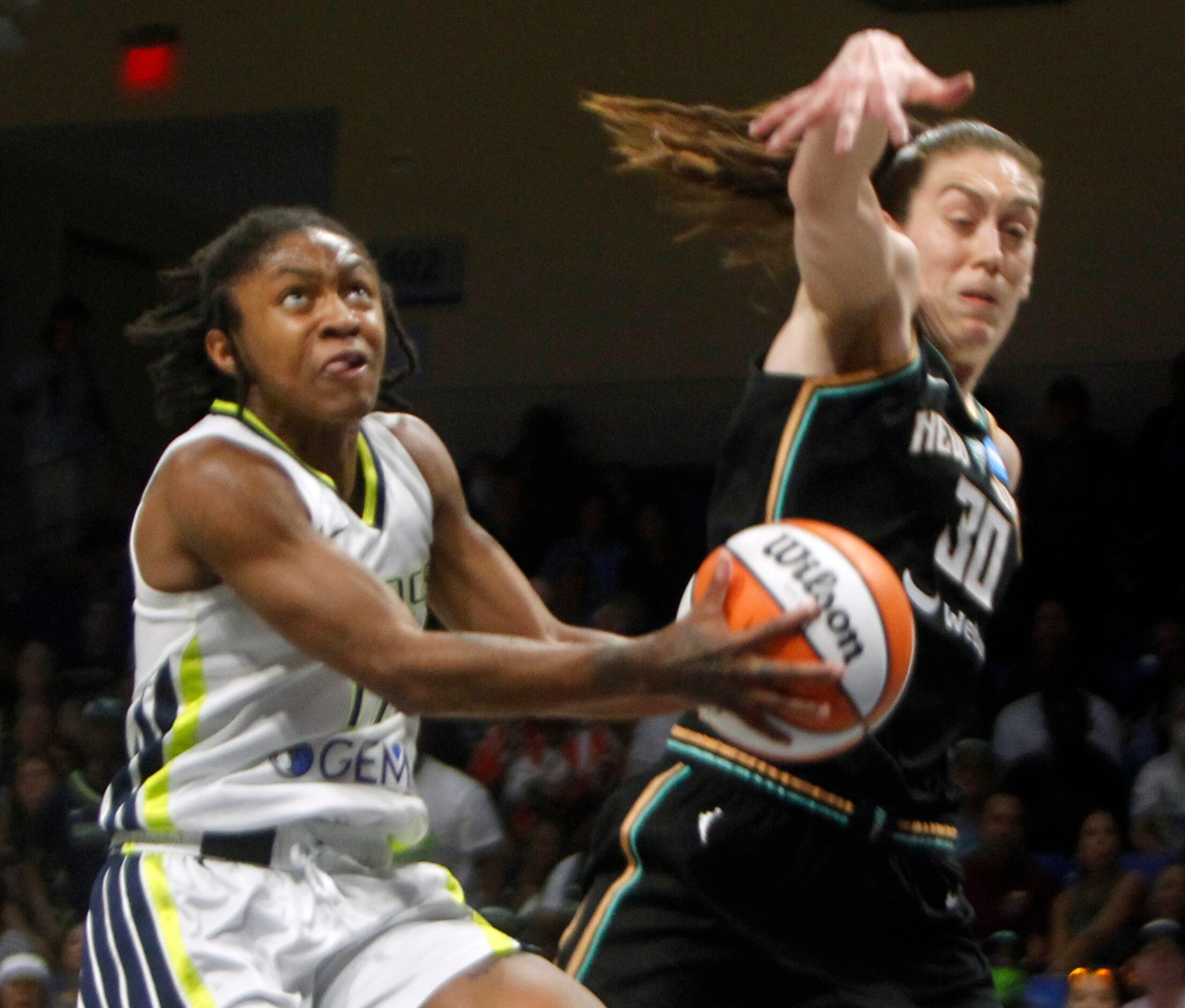 Dallas Wings guard Crystal Dangerfield (11) drives to the basket as she is defended by New...