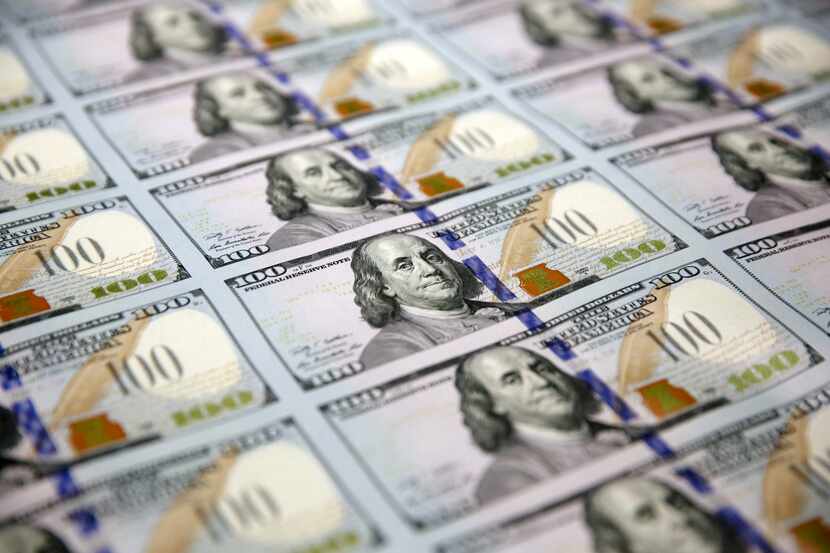 A sheet of uncut $100 bills makes the way through the printing process at the Bureau of...