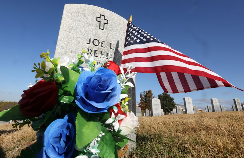 After a ceremony with speeches and military songs, family members laid wreaths at the graves...