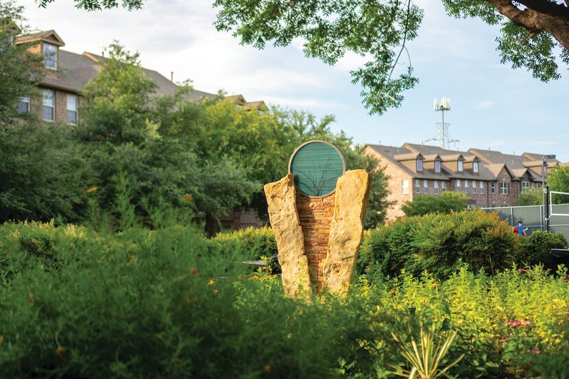 A sculpture with limestone and a tree