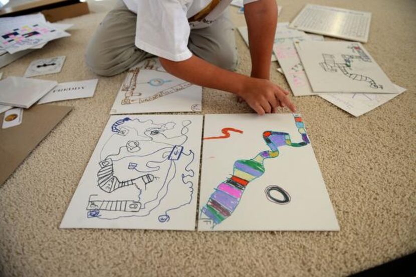 Franklin Wright, 8, explains the rules of one of the board games he created at his Frisco...