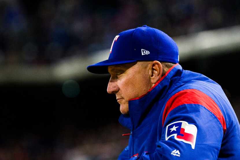 Texas Rangers manager Jeff Banister (28) watches from the dugout during the eighth inning of...