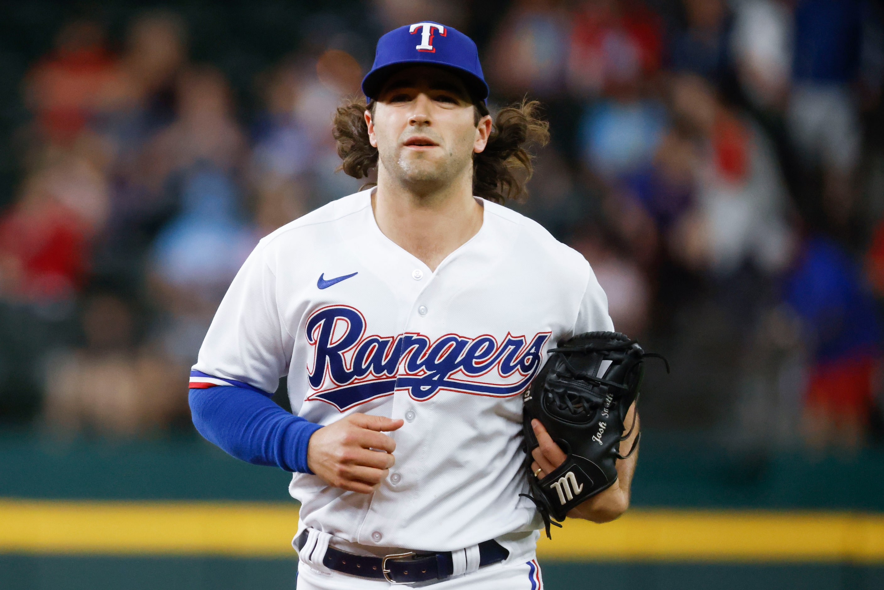 Texas Rangers shortstop Josh Smith leaves the field after the sixth inning of a baseball...