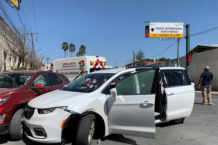 A member of the Mexican security forces stands next to a white minivan with North Carolina...