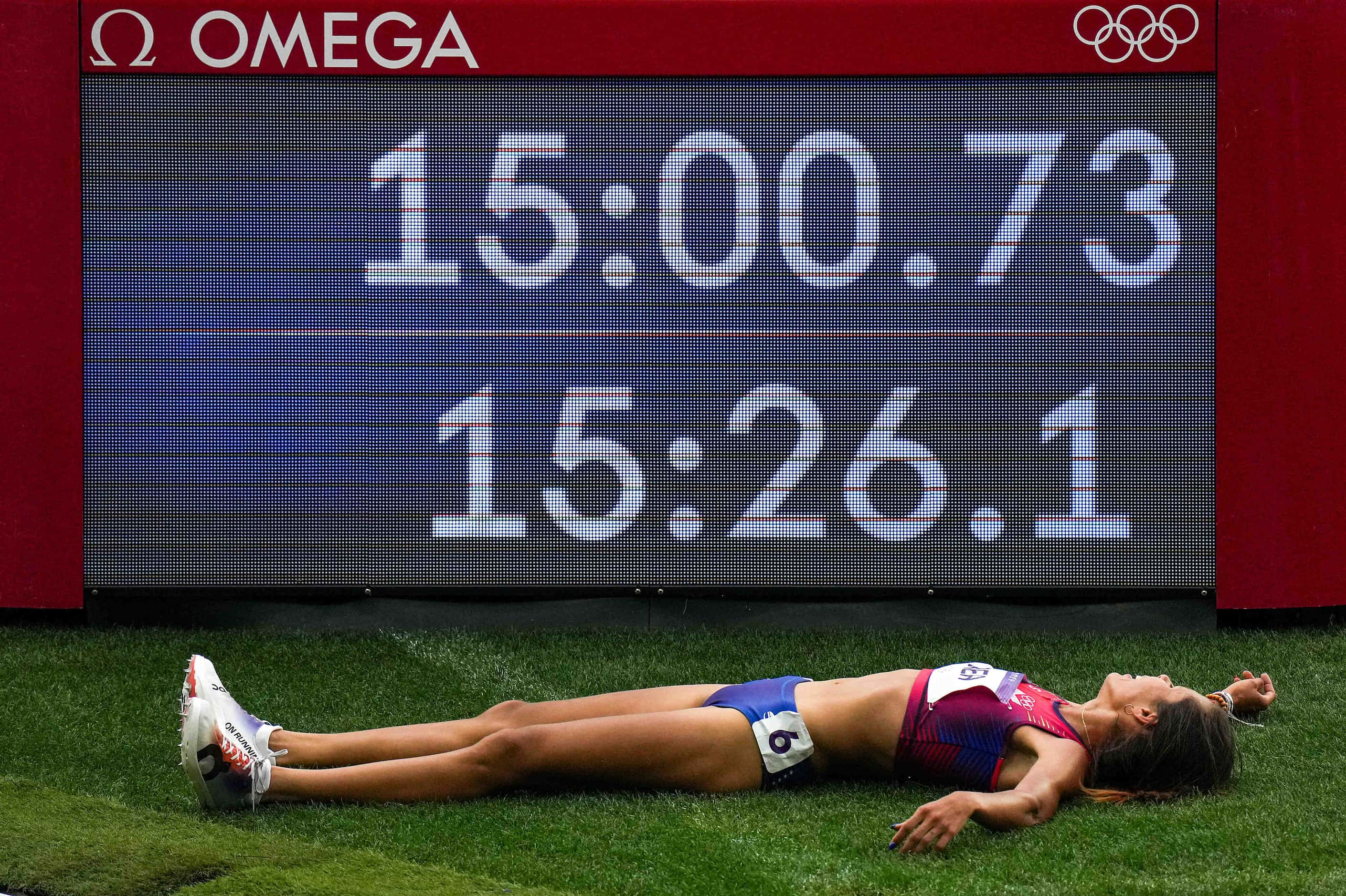 Joselyn Brea of Venezuela collapses on the infield after qualifying for the next round in a...