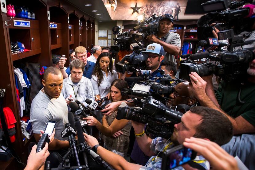 Texas Rangers third baseman Adrian Beltre is surrounded by media as he cleans out his locker...