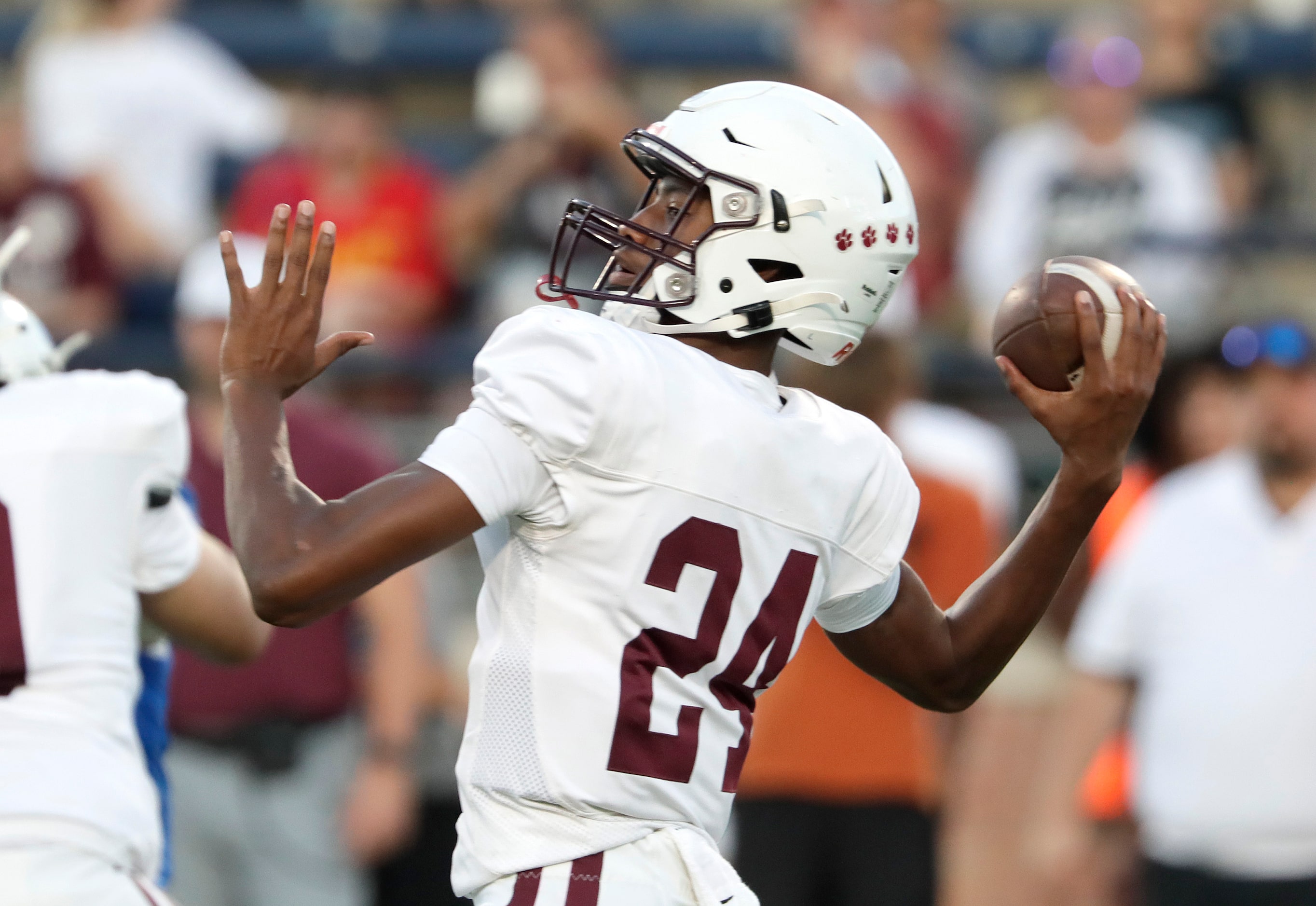 Plano High School quarterback Tyree Fisher (24) throws a pass during the first half as Allen...