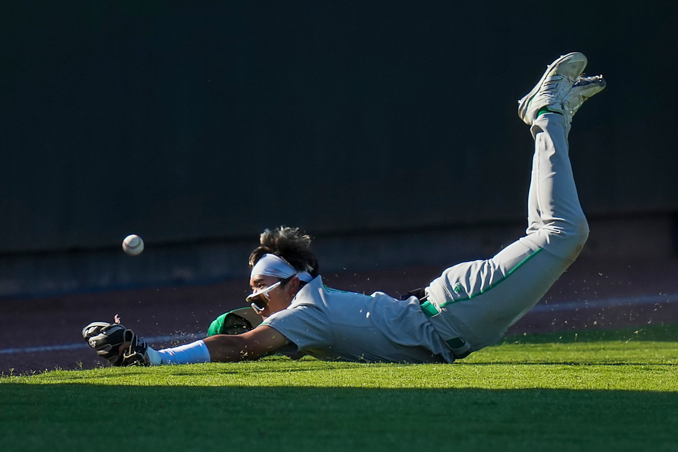 Southlake Carroll left fielder Max Reyes can’t come up with a diving catch during the sixth...
