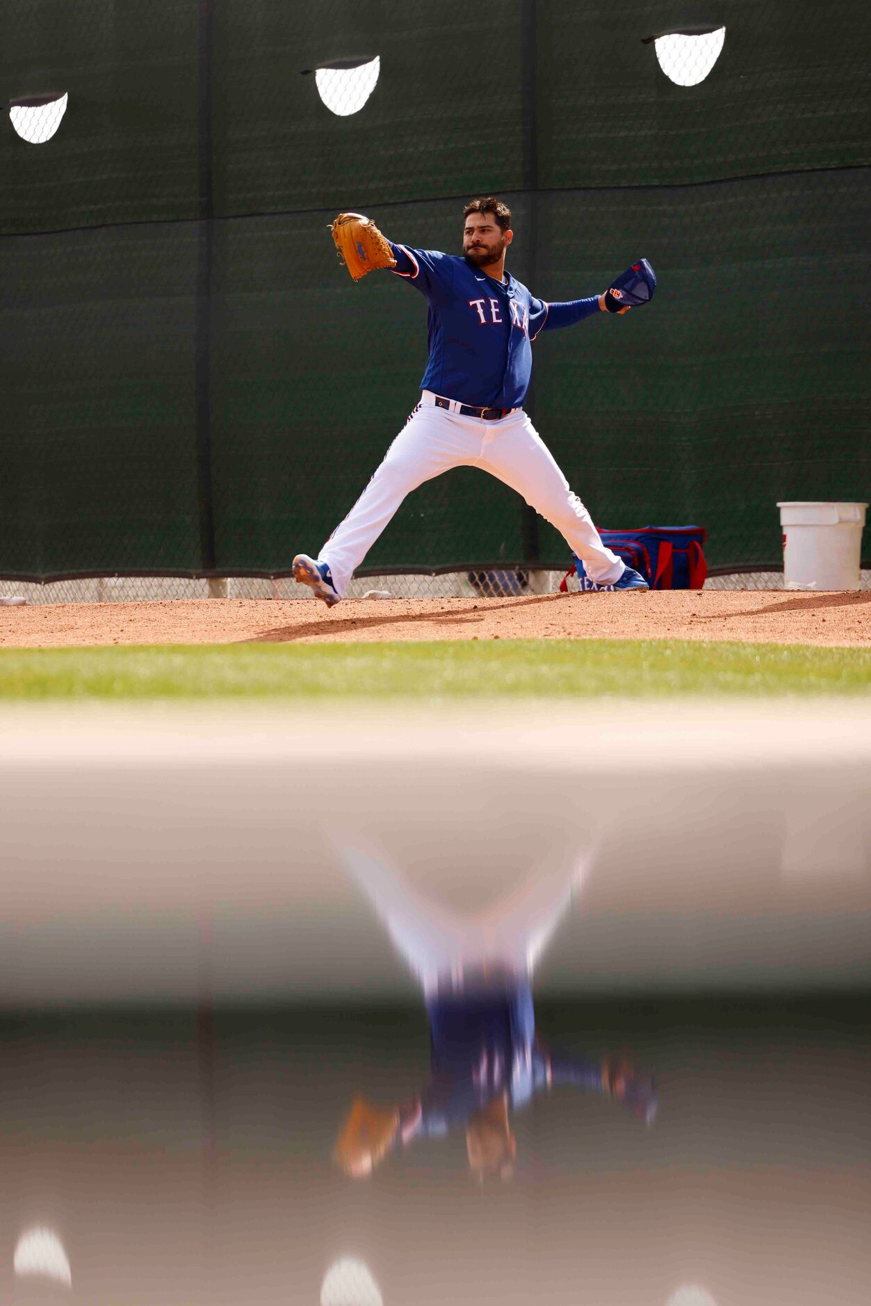 Texas Rangers pitcher Martín Pérez warms up during a spring training workout at the team's...