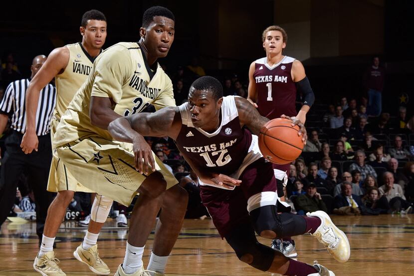 NASHVILLE, TENNESSEE - FEBRUARY 04:  Jalen Jones #12 of the Texas A&M Aggies drives into...