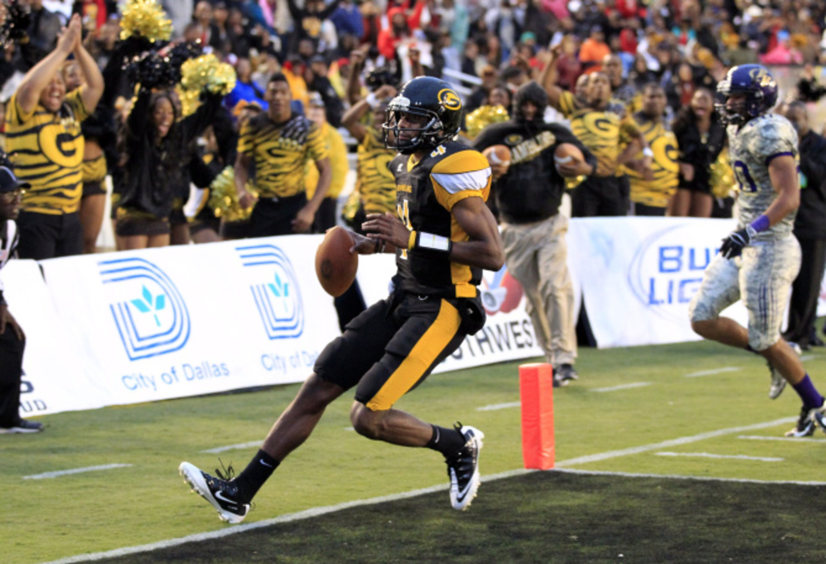 Grambling quarterback D.J. Williams (4) scrambles into the end zone for a touchdown during...