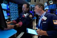 FILE - Specialist Michael Pistillo, left, and trader Robert Charmak work on the floor of the...