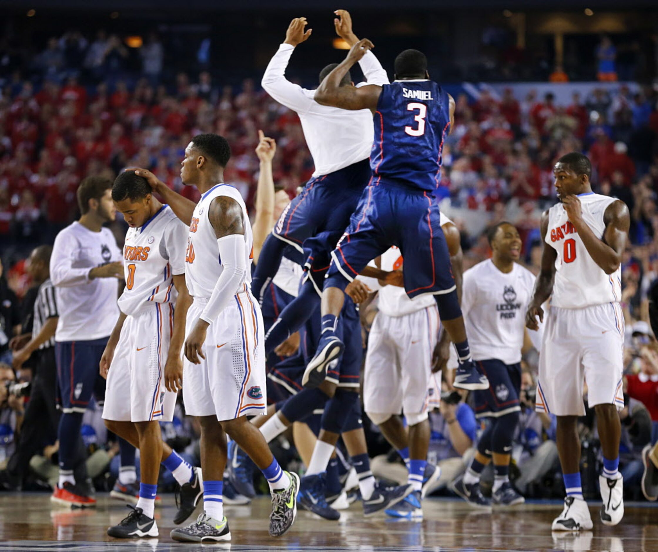 Florida Gators guard Michael Frazier II (20) comforts guard Kasey Hill (0, left) as the...