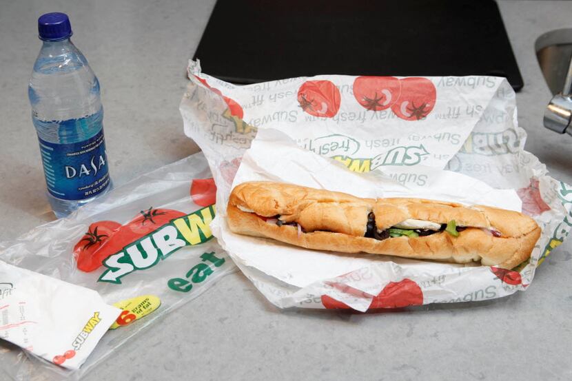 FILE - This Aug. 11, 2009, file photo, shows a chicken breast sandwich and water from subway...