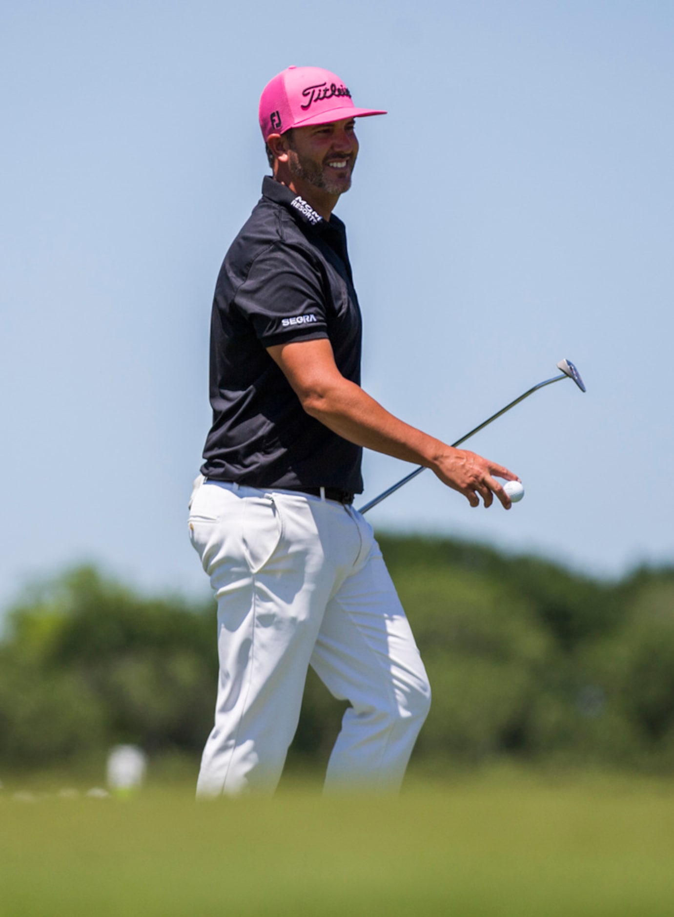 Scott Piercy smiles after sinking a putt on hole 6 during round 4 of the AT&T Byron Nelson...