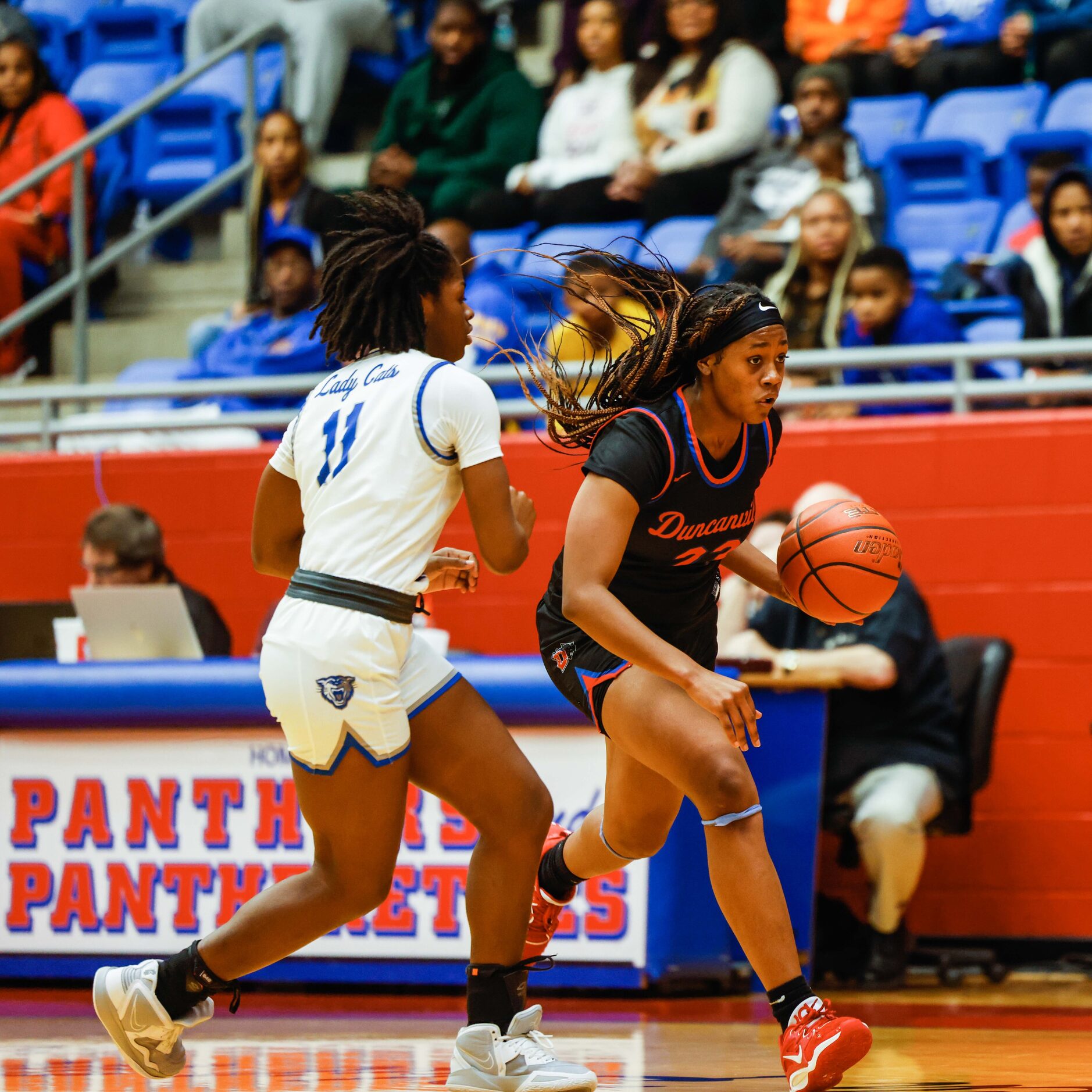 Duncanville Pantherettes' Mariah Clayton (23) dribbles the basketball against Conway Lady...