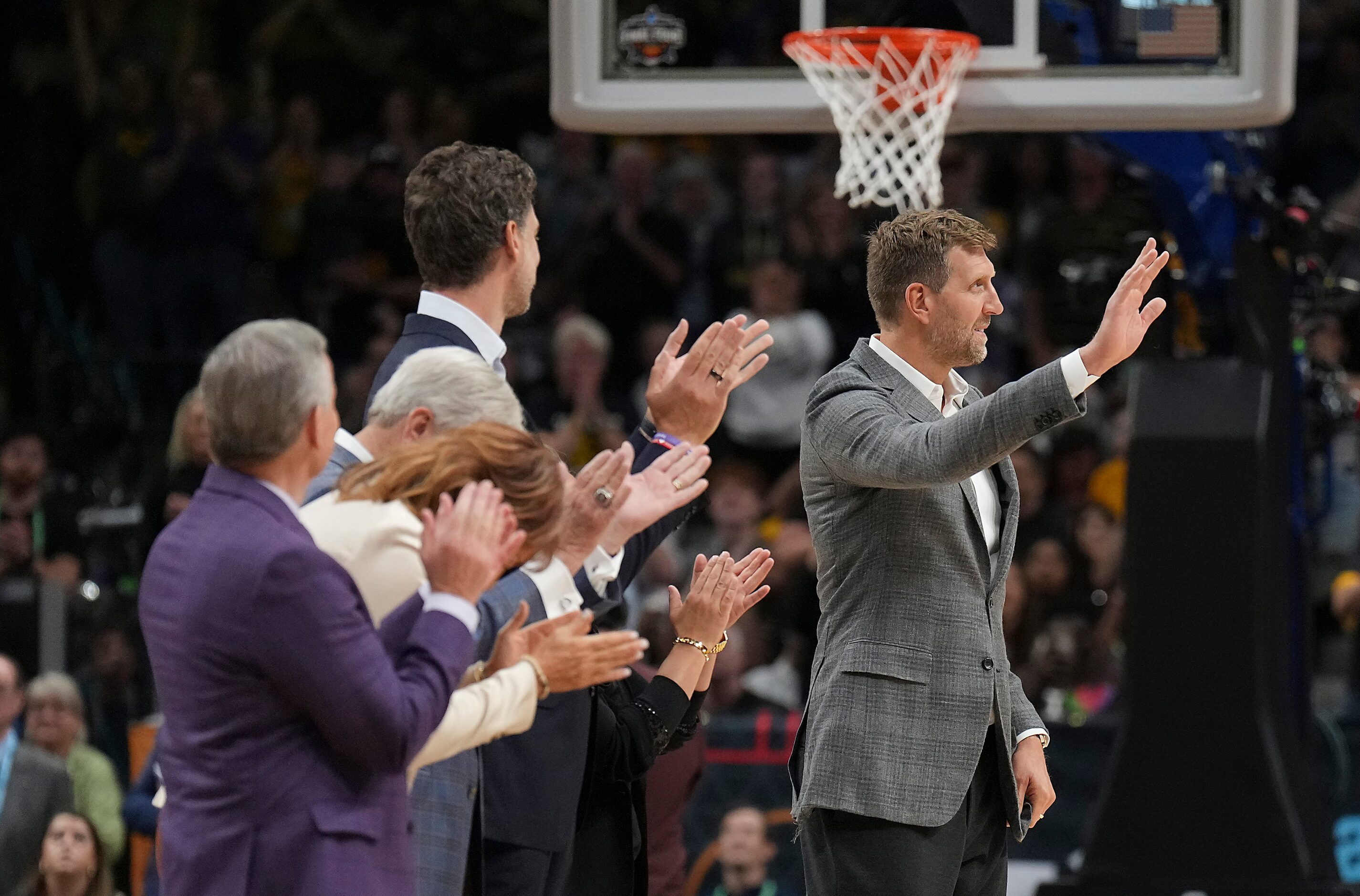 Dirk Nowitzki waves to the crowd while being recognized during a time out in the first half...