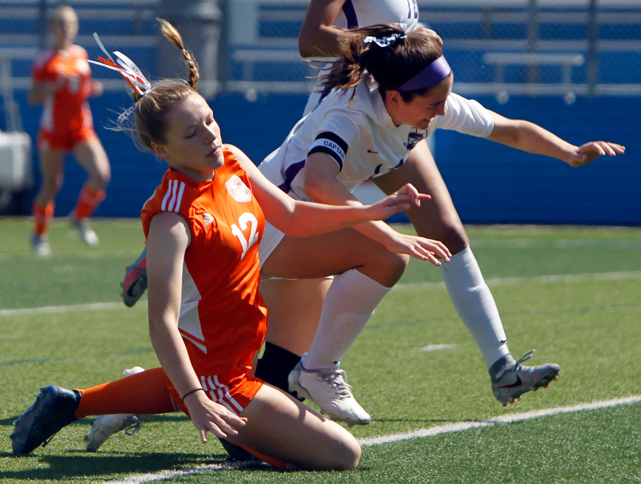 Celina's Grace Pritchard (12), left, collides with Boerne's Lily Griffith (12) after...