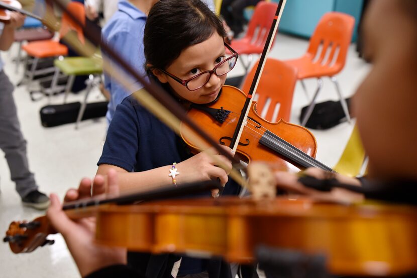 Estrella Hernandez teams with a classmate for a group exercise as the two students practice...