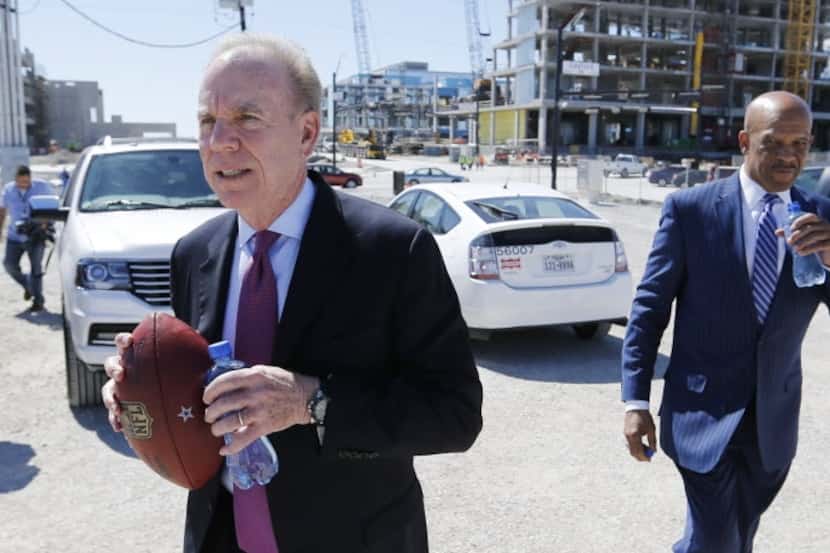 Former Dallas Cowboys Roger Staubach and Drew Pearson walk back to the tent after giving an...