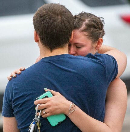 Scott Bowers embraces his fiancée, Kimberly Wohled, after authorities escorted him out of...