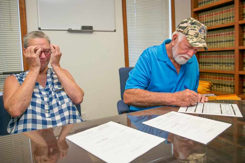 Fran  and Dan Keller look over court document declaring them innocent of the alleged sexual...