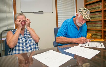 Fran  and Dan Keller look over court document declaring them innocent of the alleged sexual...