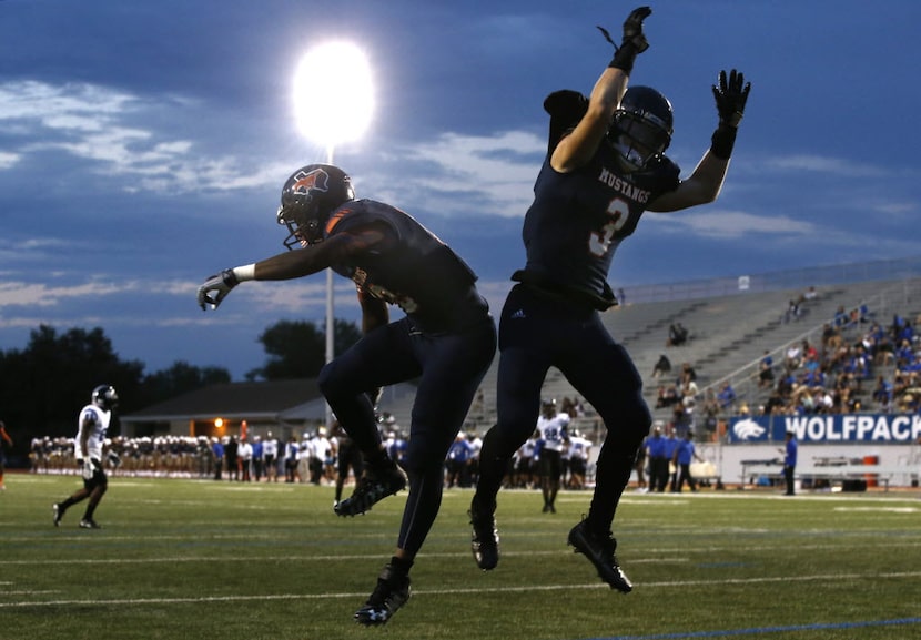 Sachse wide receivers DeAndre Kennedy and Nate Shelton (3) celebrate a touchdown against...