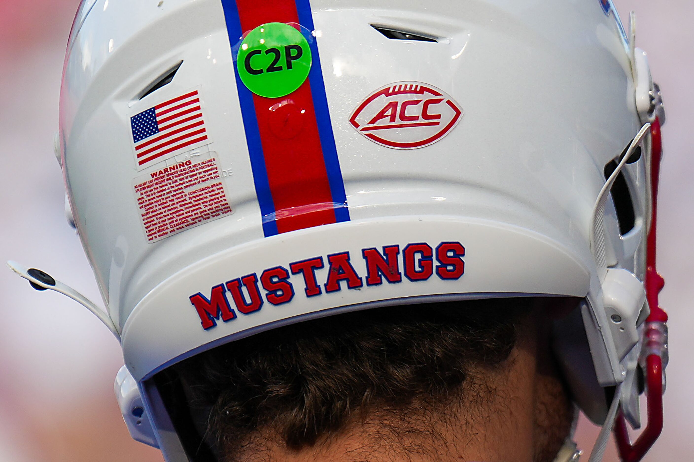 The ACC logo is seen on his helmet as SMU quarterback Preston Stone warms up before an NCAA...