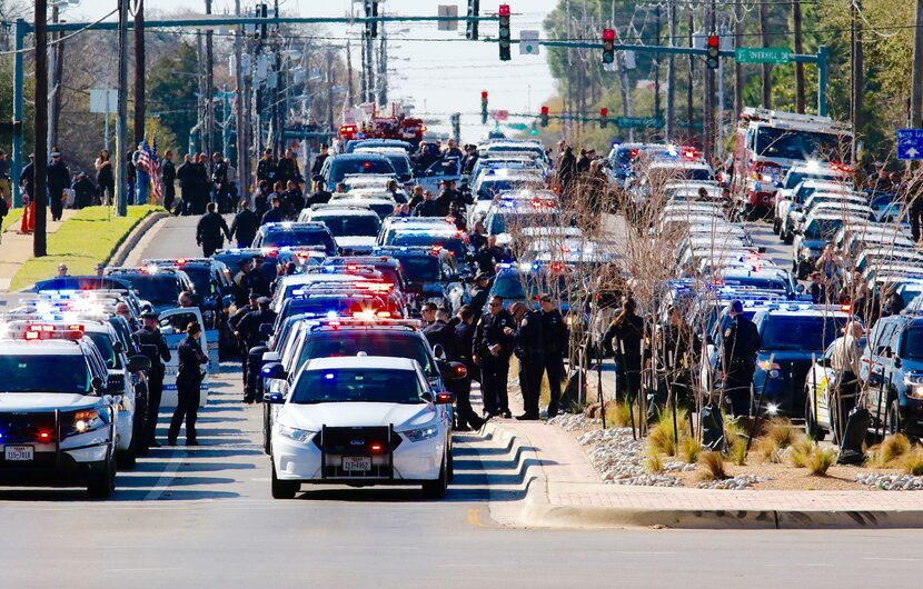  Law enforcement officers gather on Precinct Line Rd. and highway 183 on Saturday, March 5,...