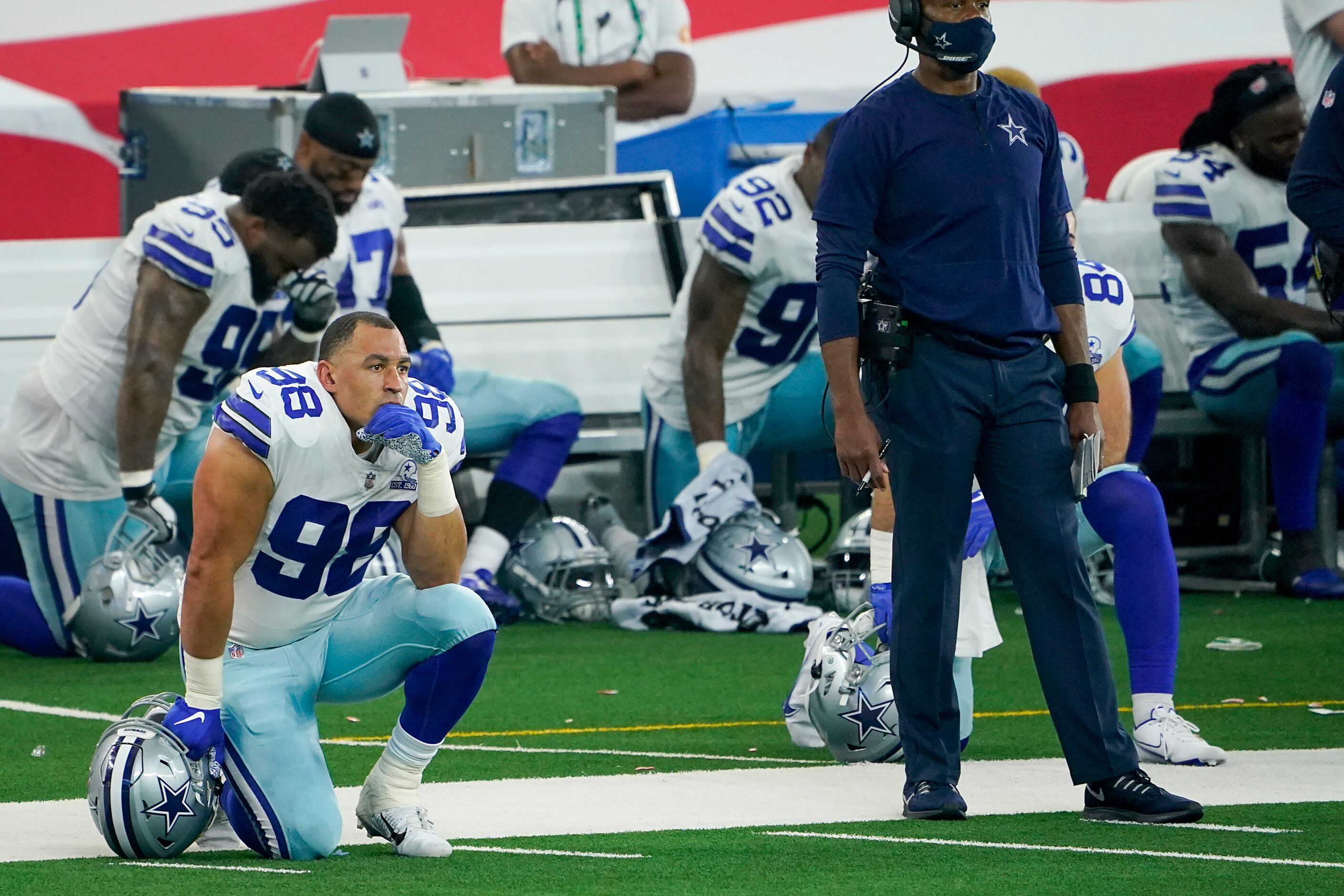 Dallas Cowboys defensive tackle Tyrone Crawford takes a knee as quarterback Dak Prescott...