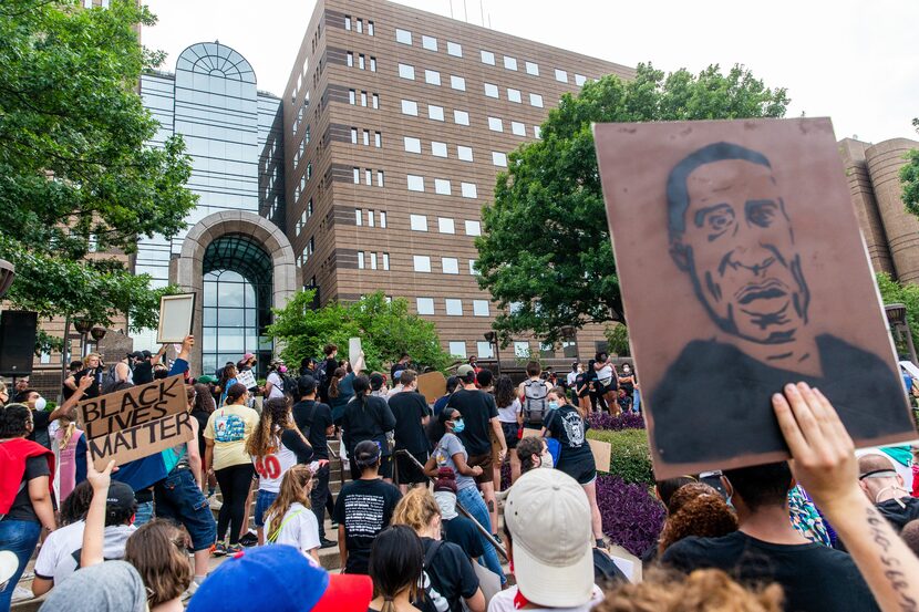 Protesters gather outside the Frank Crowley Courts building past the city’s 7 p.m. curfew...