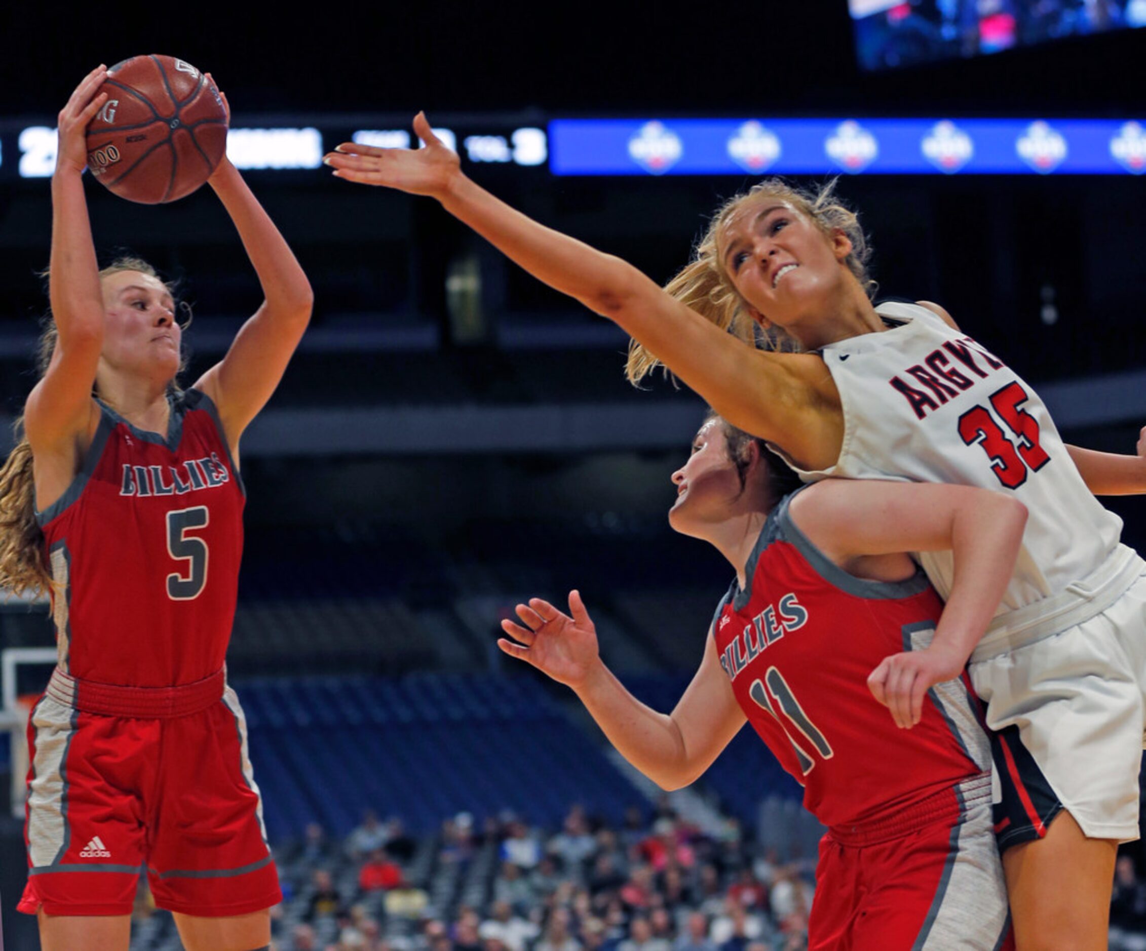 Argyle forward Shelby Henches #35 reaches over Fredericksburg guard Brittley Bowers #11in 4A...